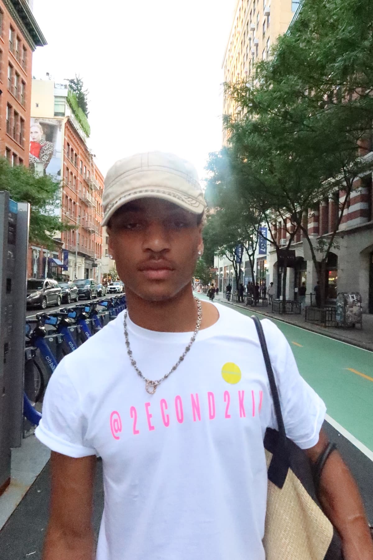 FaurY walking past a row of Citi Bikes on a Soho street