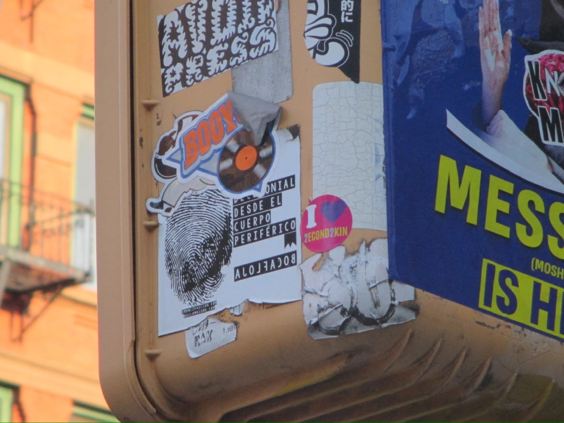 Close-up detail shot of stickers on a Soho street pole