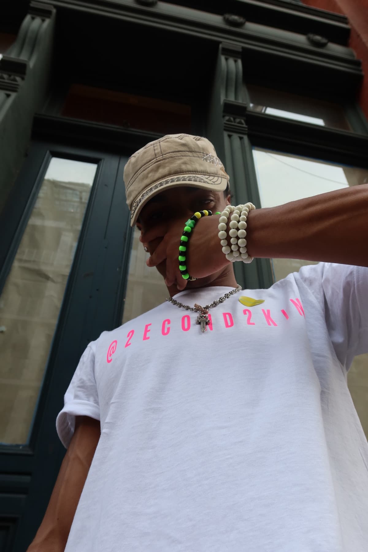Close-up of FaurY's arm and bracelets against a doorway