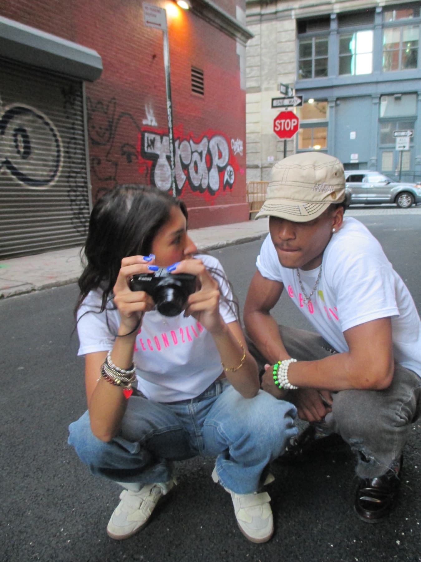 FaurY and a model crouched together over a camera