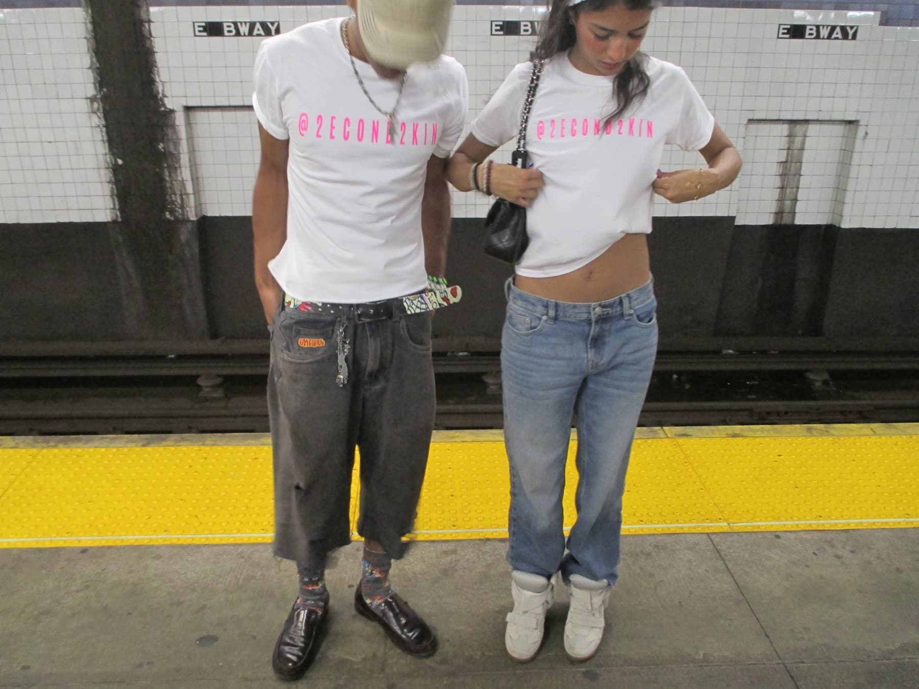 FaurY and a model at a subway platform, heads down