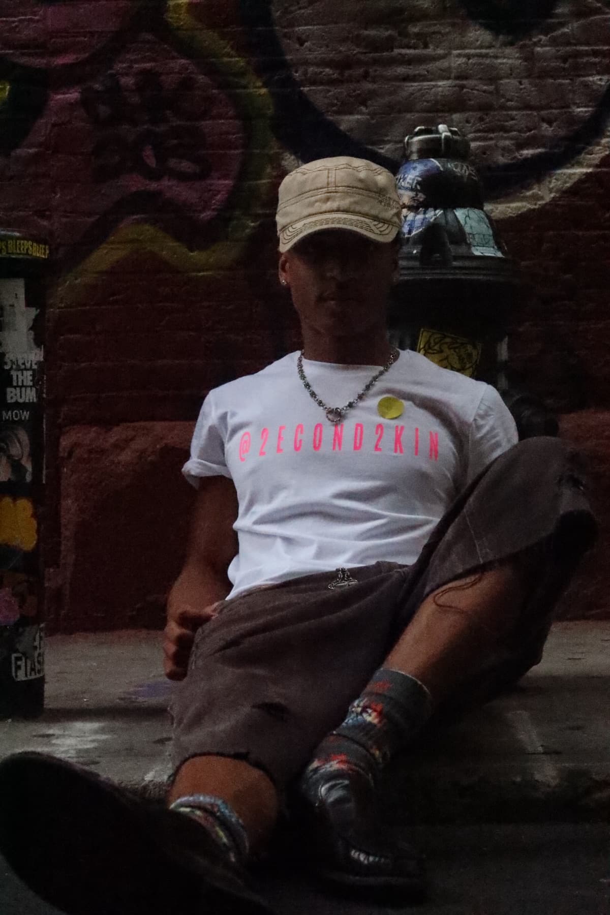 FaurY seated in a dimly lit alley