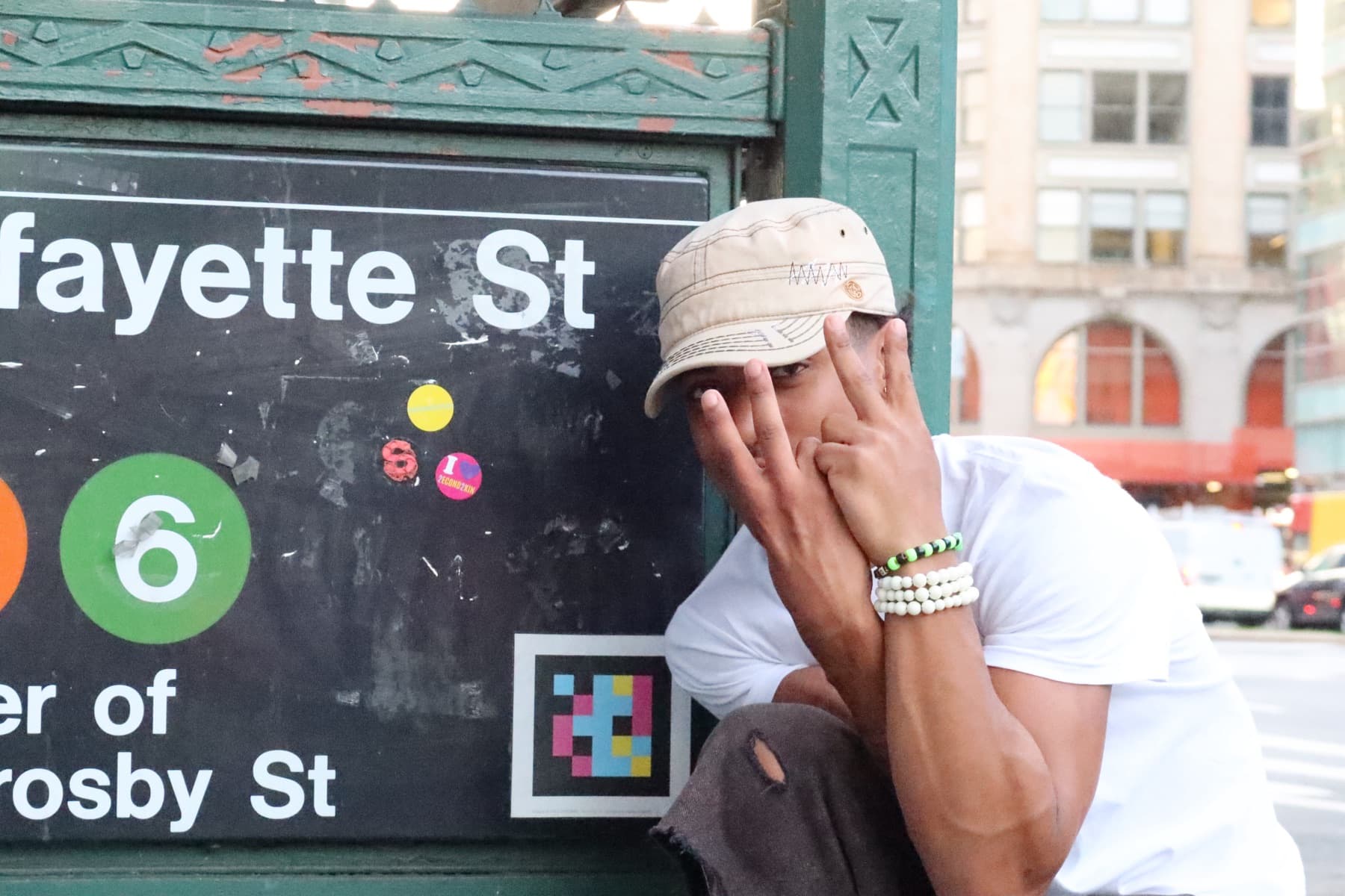 FaurY beside a subway station sign, close angle