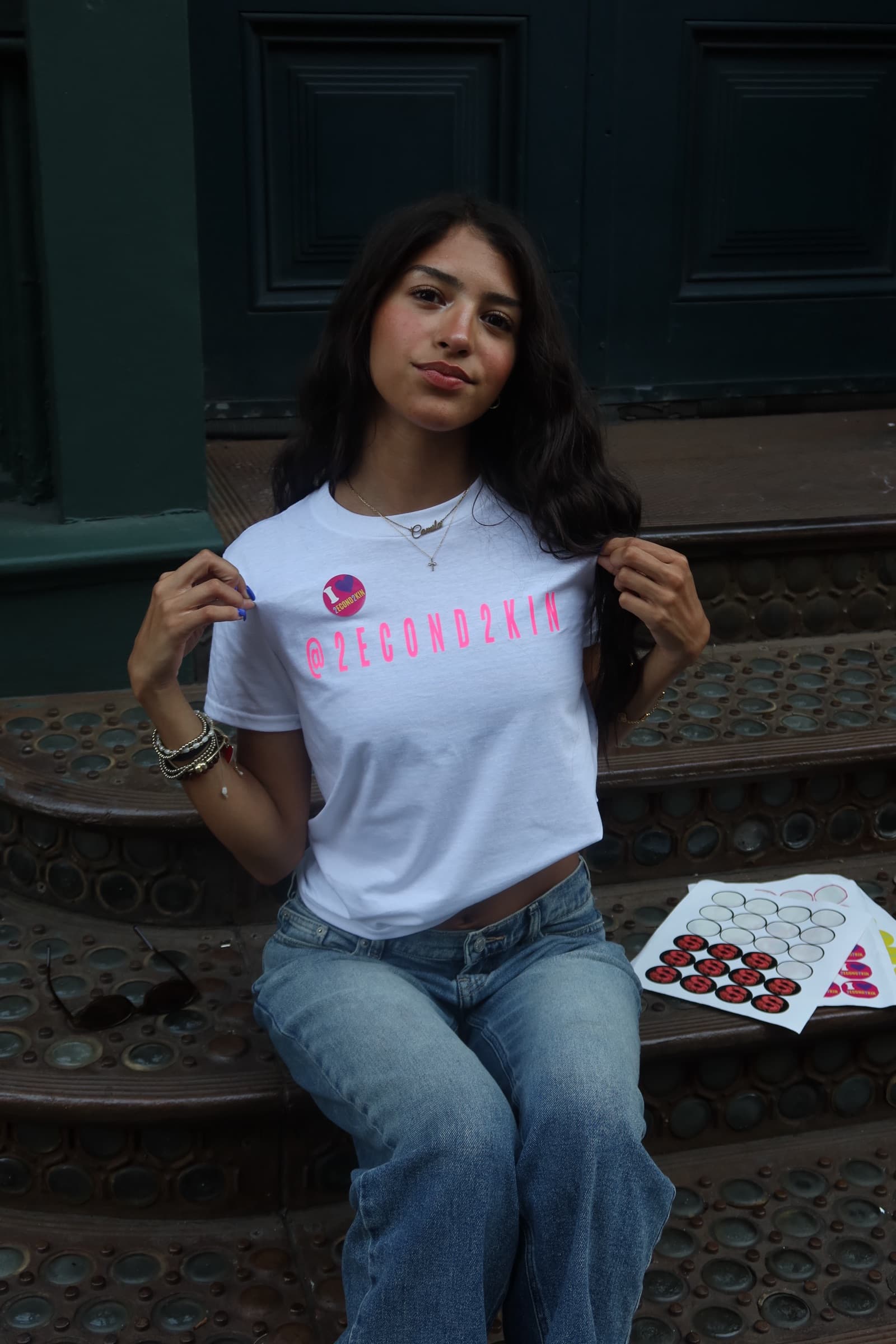 Camila Peña Del Real, founder of 2econd2kin Magazine, seated on a Soho stoop